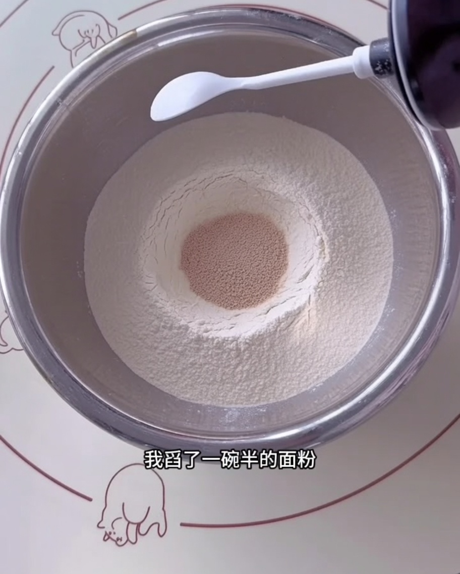 Dry flour, yeast, salt, and sugar measured into a large stainless steel mixing bowl.