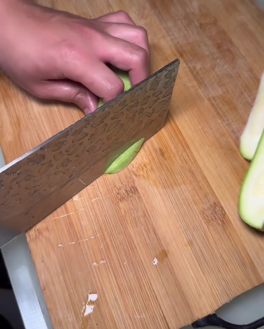 Thick slices of fresh, seeded zucchini ready to be added to the pot.