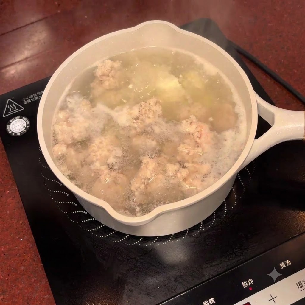 Salted plum liquid being poured from a bowl into the bubbling pot of soup.