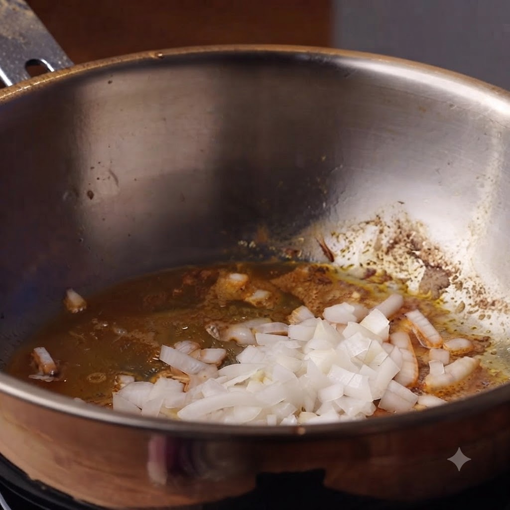 Chopped onions and garlic cooking in oil inside a deep pot.