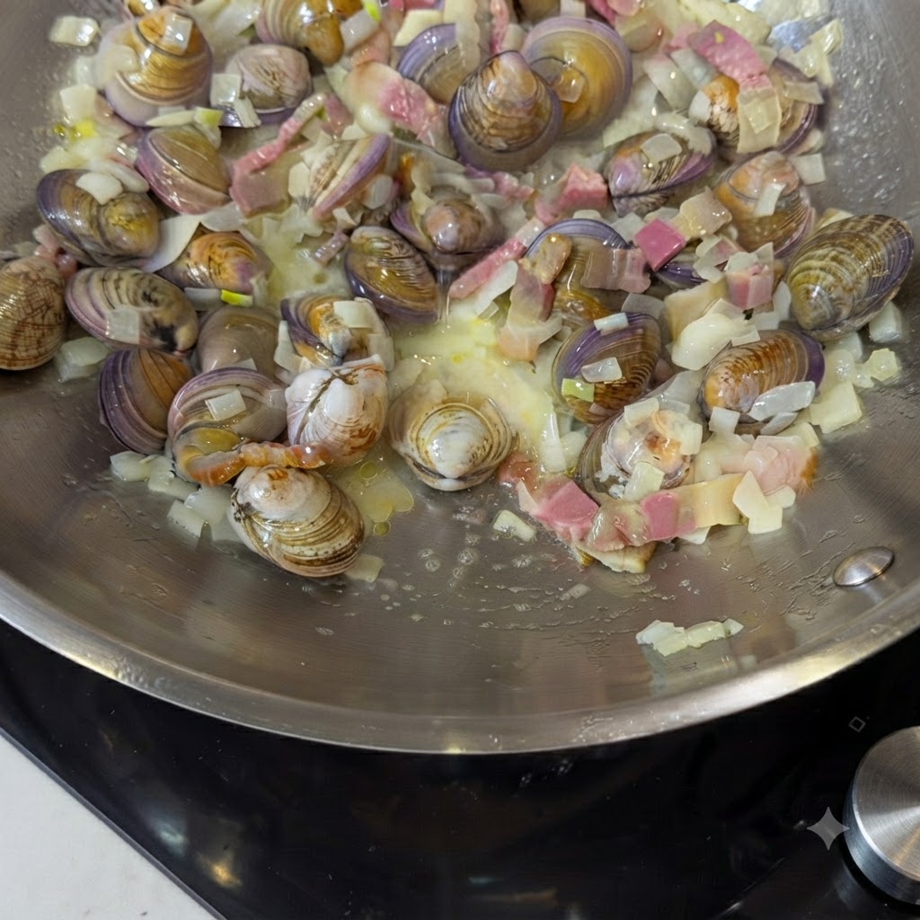 Water and bay leaves being added into the pan with the ingredients.