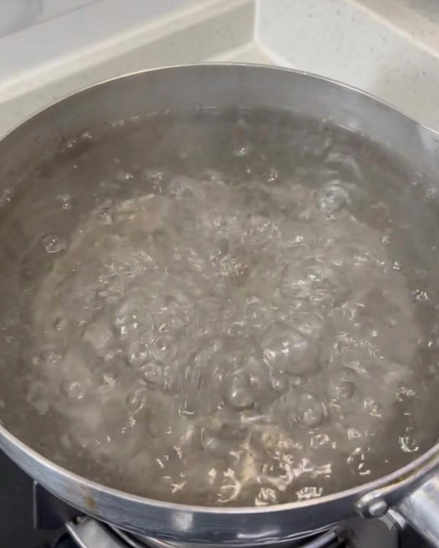 Coarse salt dissolving in a large pot of violently boiling water.