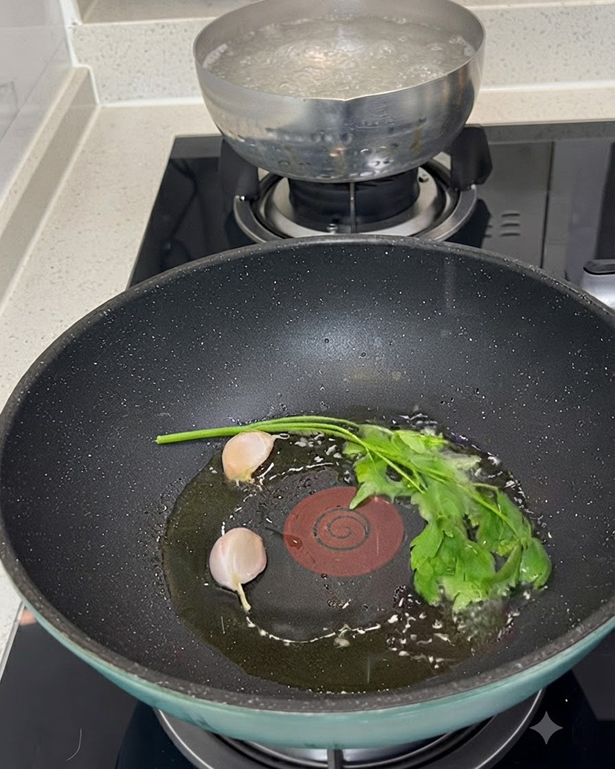 Raw clams, two peeled garlic cloves, and a sprig of fresh green parsley resting in olive oil inside a pan.