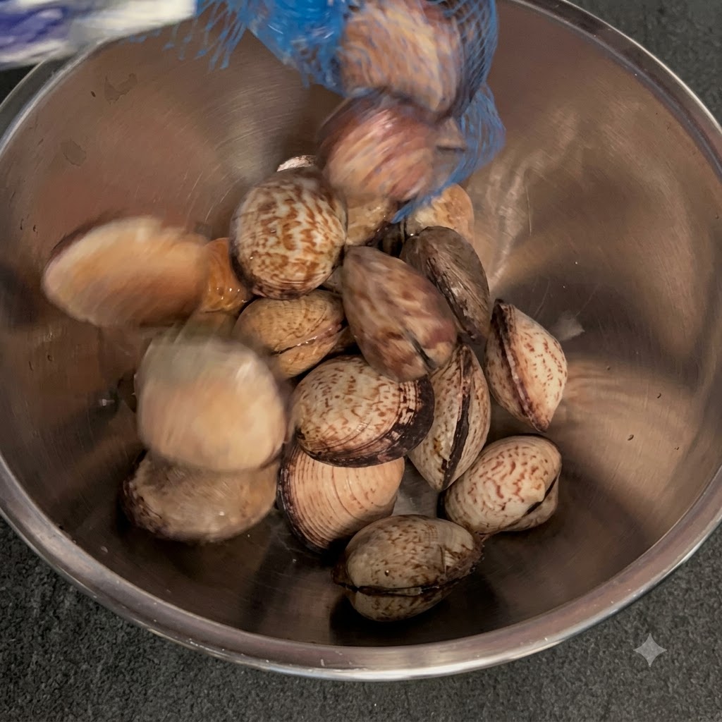 Clams being placed into a metal bowl filled with warm water and salt.