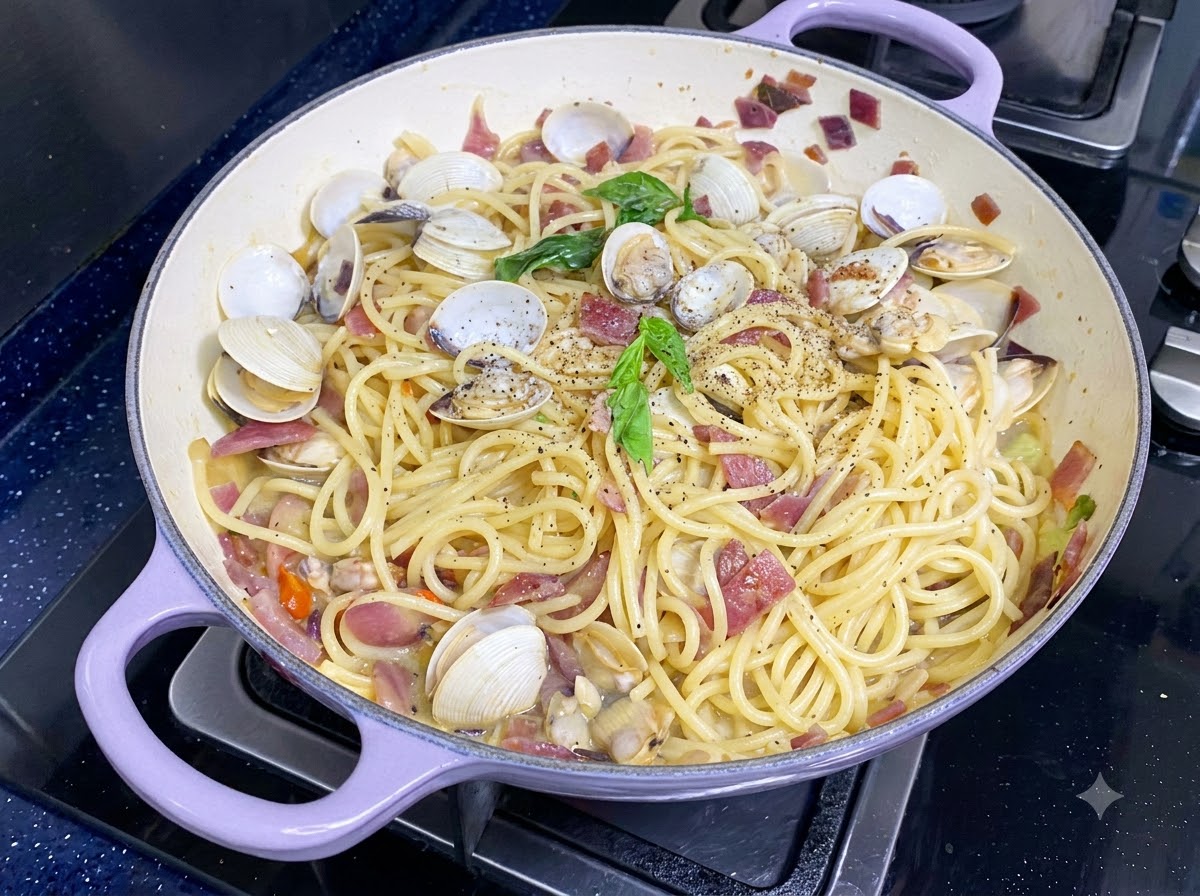 Fresh green basil leaves placed on top of finished clam spaghetti.