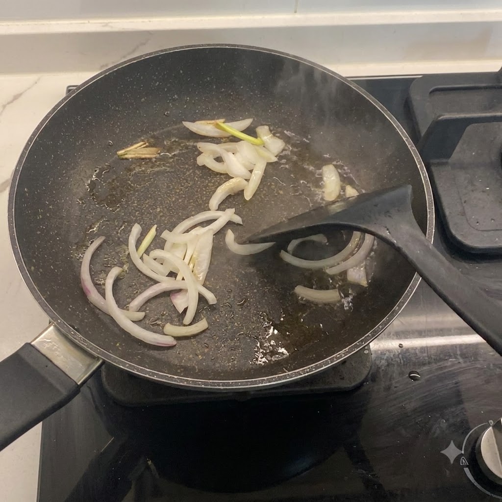 Sliced onions and green onions frying in a hot pan with oil.