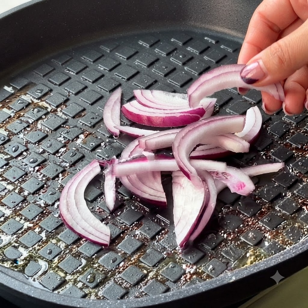 Sliced red onion and kimchi being added into the pan.