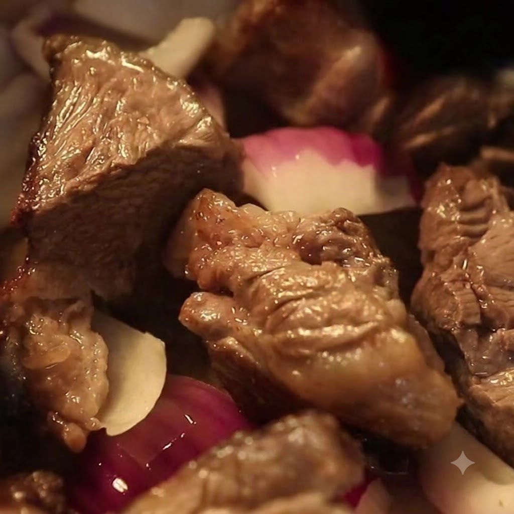 Light soy sauce being poured over beef and onions in the pot.