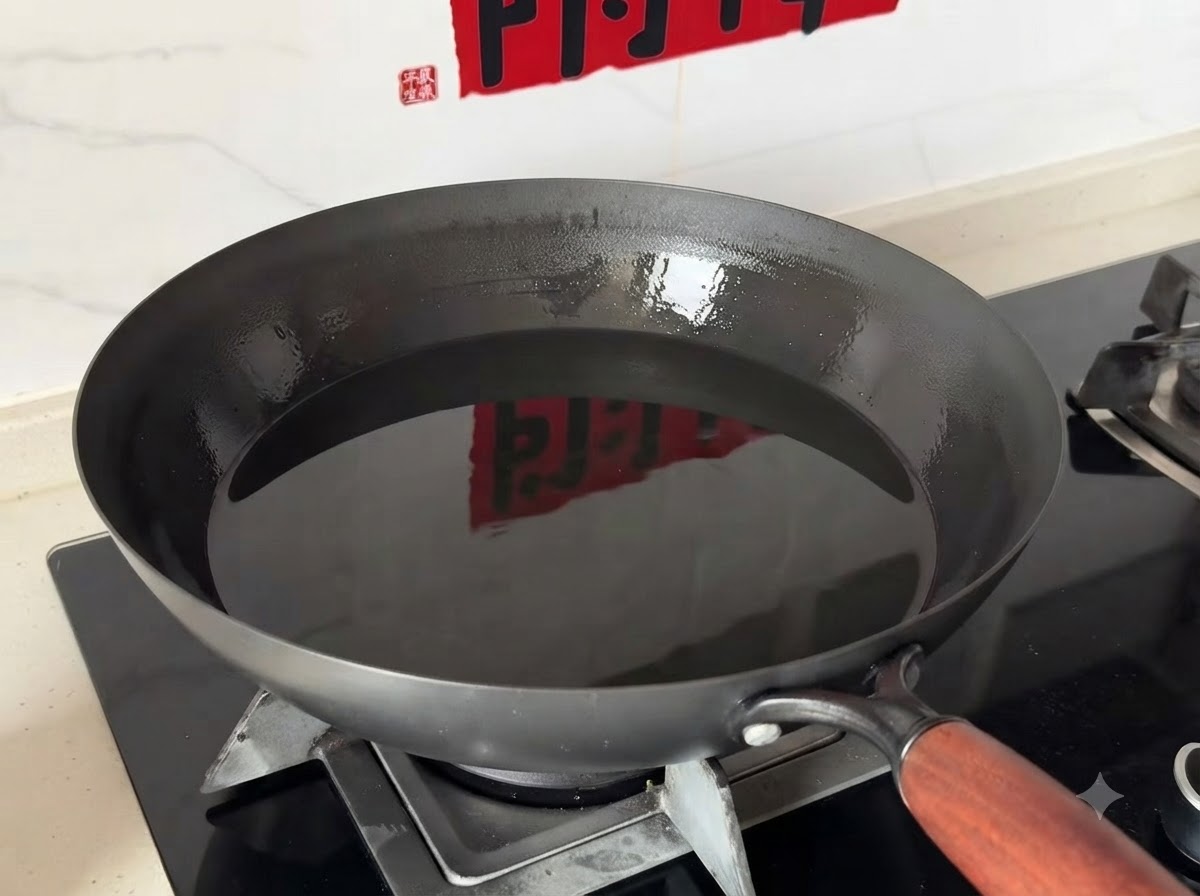 A deep wok filled with clean cooking oil sitting on a gas stove burner.