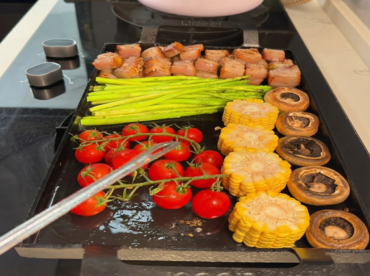 Carrots added to the grilling spread on the teppanyaki pan.