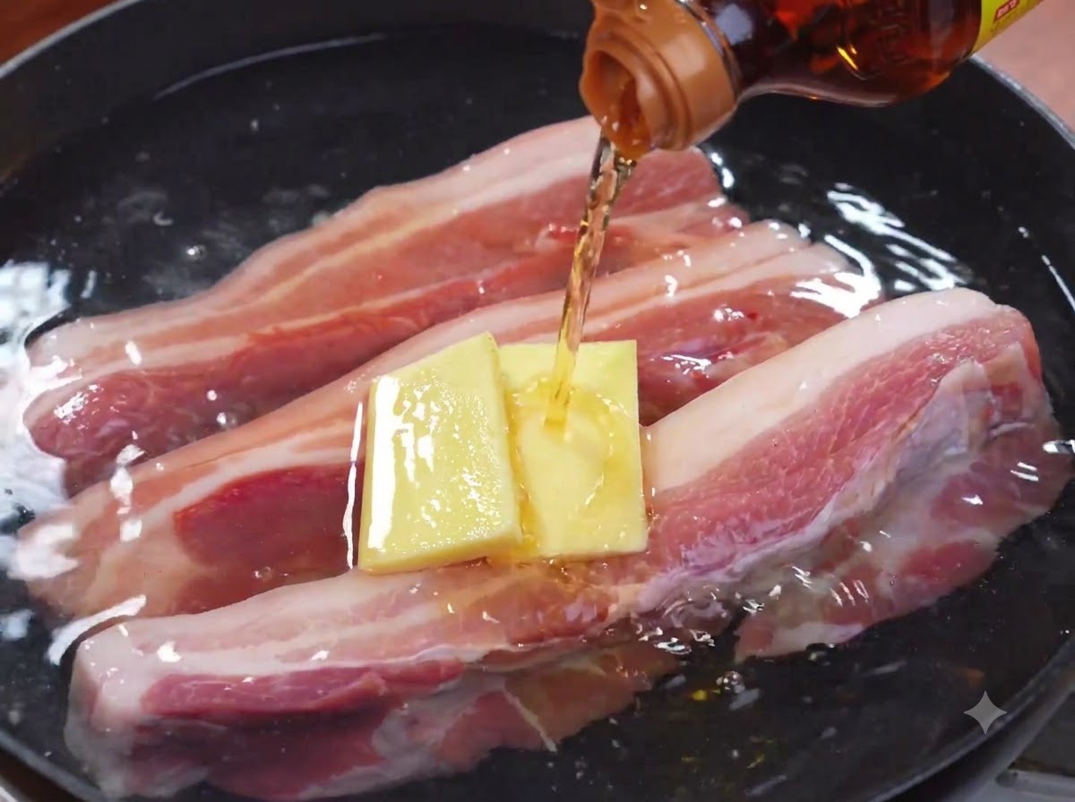 Boiled strips of pork belly being removed from a pot with kitchen tongs.