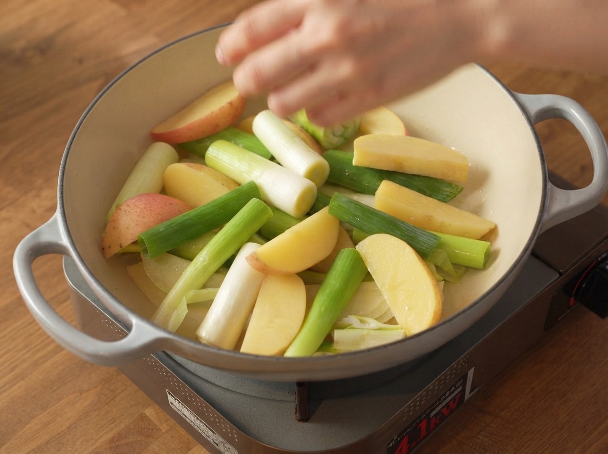 Seasoned raw pork belly strips placed securely on top of the vegetable layer inside the cooking pot.