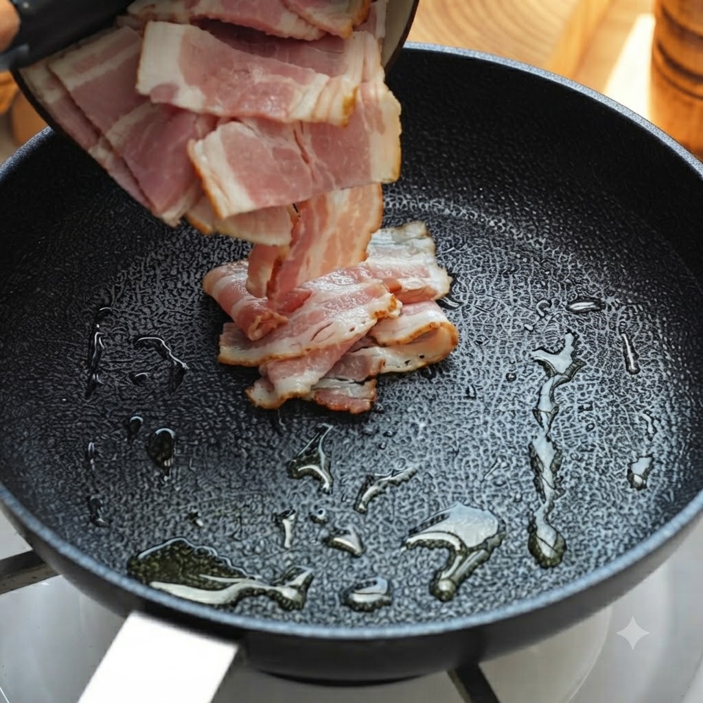 Bacon strips being poured and cooked in an oiled frying pan.