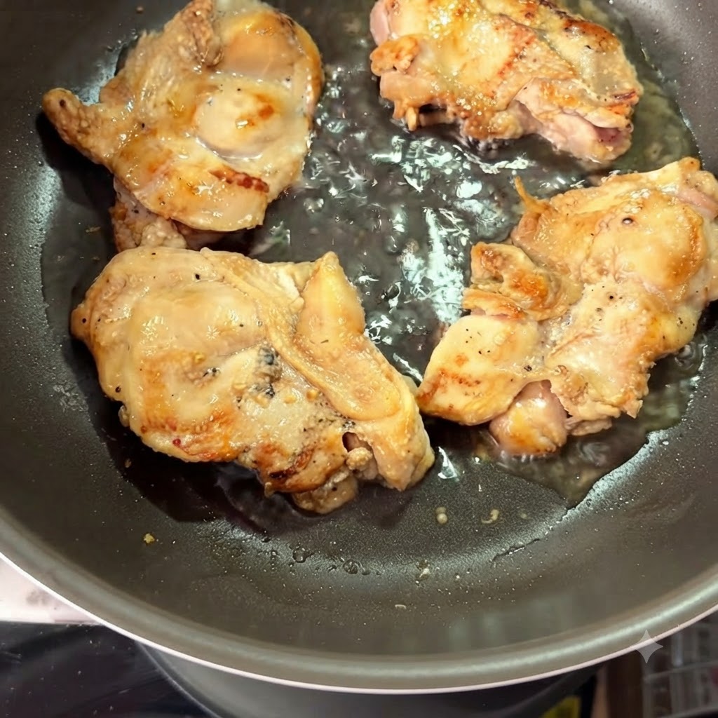 Hot water being poured into a pan surrounding seared chicken thighs.