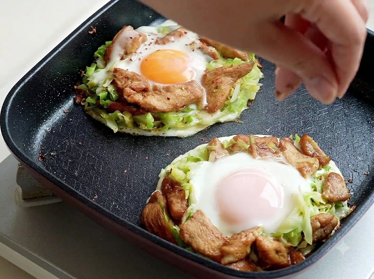 Barbecue seasoning being sprinkled from above onto the cooked frittata portions in the pan.