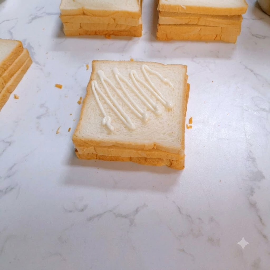 A seasoned and cooked chicken steak being laid onto the dressed slice of bread.