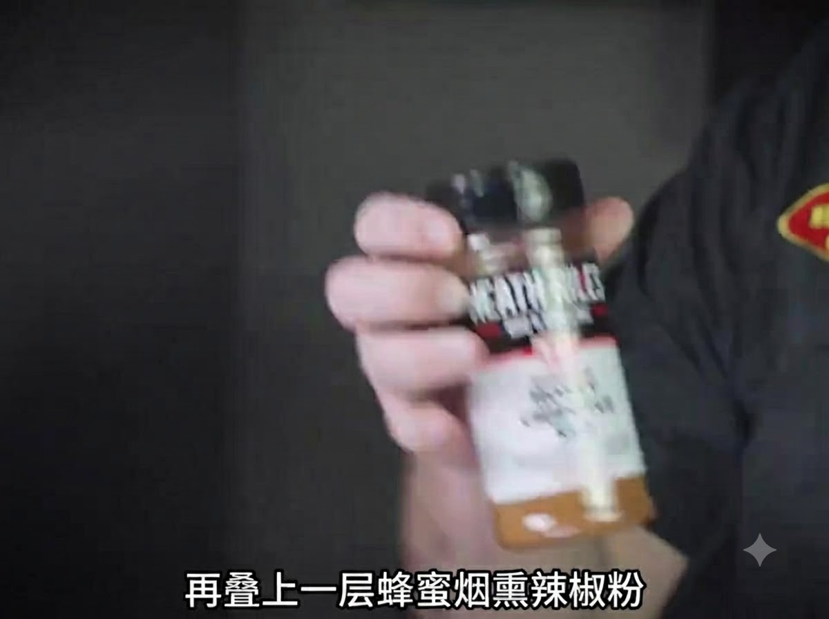 A bottle of honey chipotle barbecue seasoning held up close to the camera.
