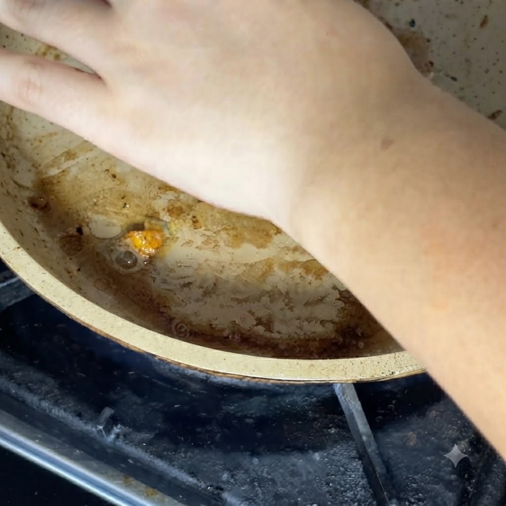 A hand placing a cheese slice over the ingredients in the hot pan.