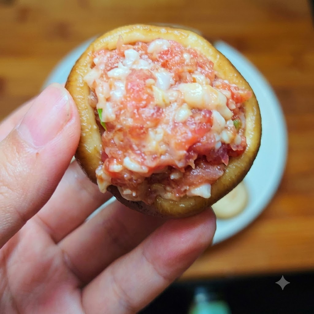 A shiitake mushroom cap tightly filled with seasoned ground meat.