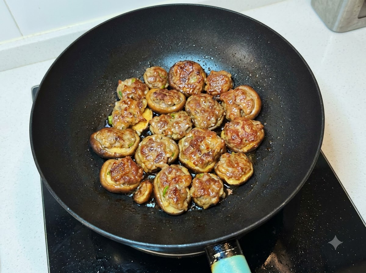Sauce mixture being poured over the cooked mushrooms in the wok.