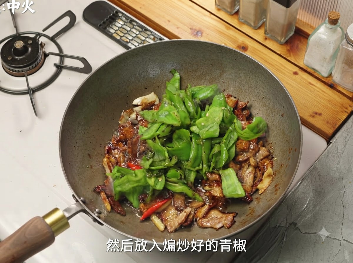 Green peppers and mushrooms being added into the wok with the seasoned pork.