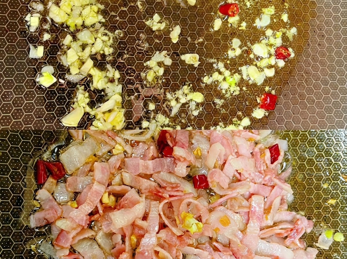 Cooked spaghetti noodles being tossed in a pan with seasonings and liquid.