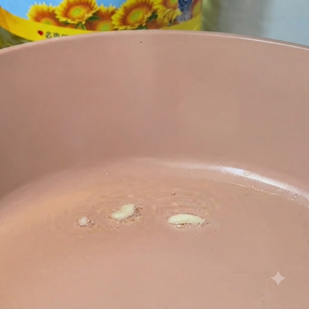 Minced garlic frying in a hot pink pan with oil.
