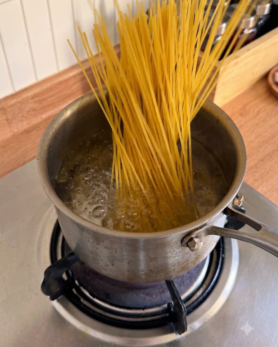Dry spaghetti noodles being inserted into a pot of bubbling boiling water.