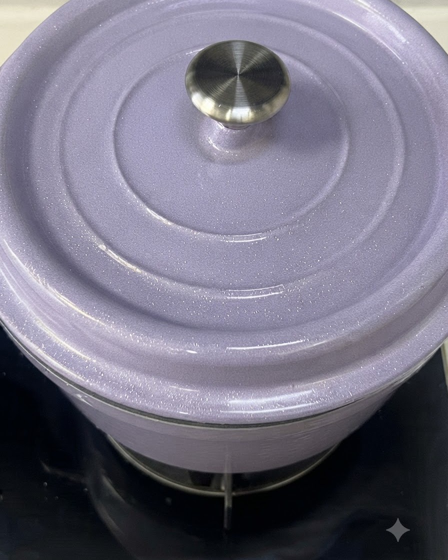 A close-up of a light purple enameled cast iron pot with its lid being placed on top.