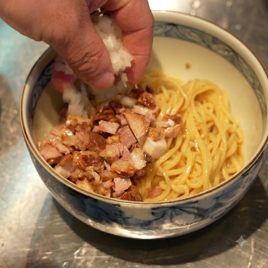 Hand sprinkling diced white onions onto the bowl containing noodles and diced chashu.