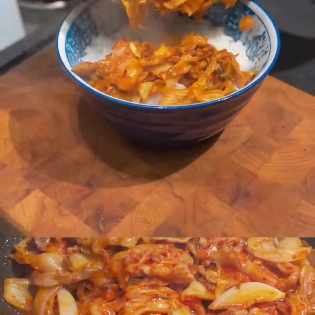 Kimchi pork stir-fry being spooned from a pan into a blue-patterned bowl filled with white rice.