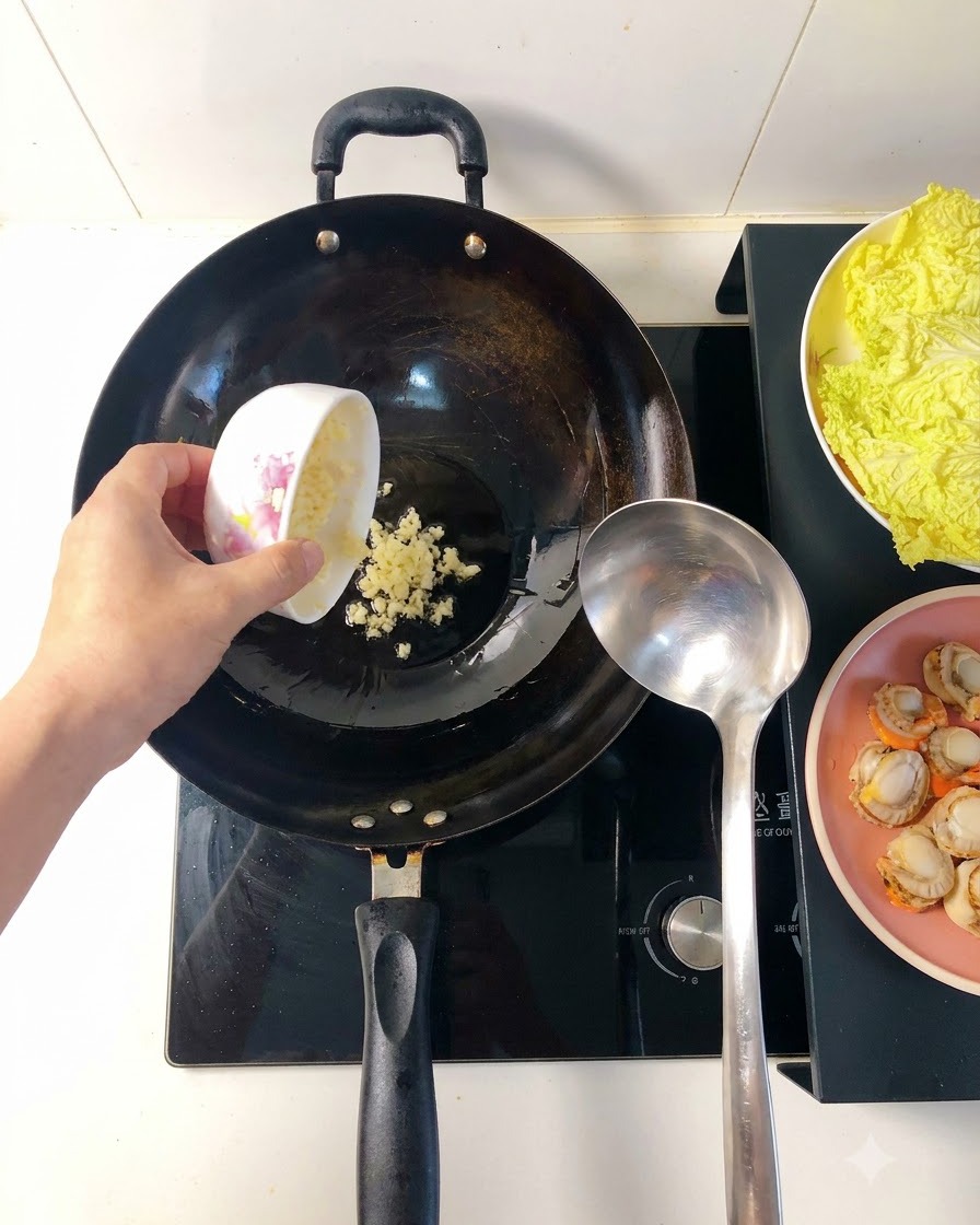 Minced garlic frying in hot oil inside a wok, turning golden and releasing aroma.