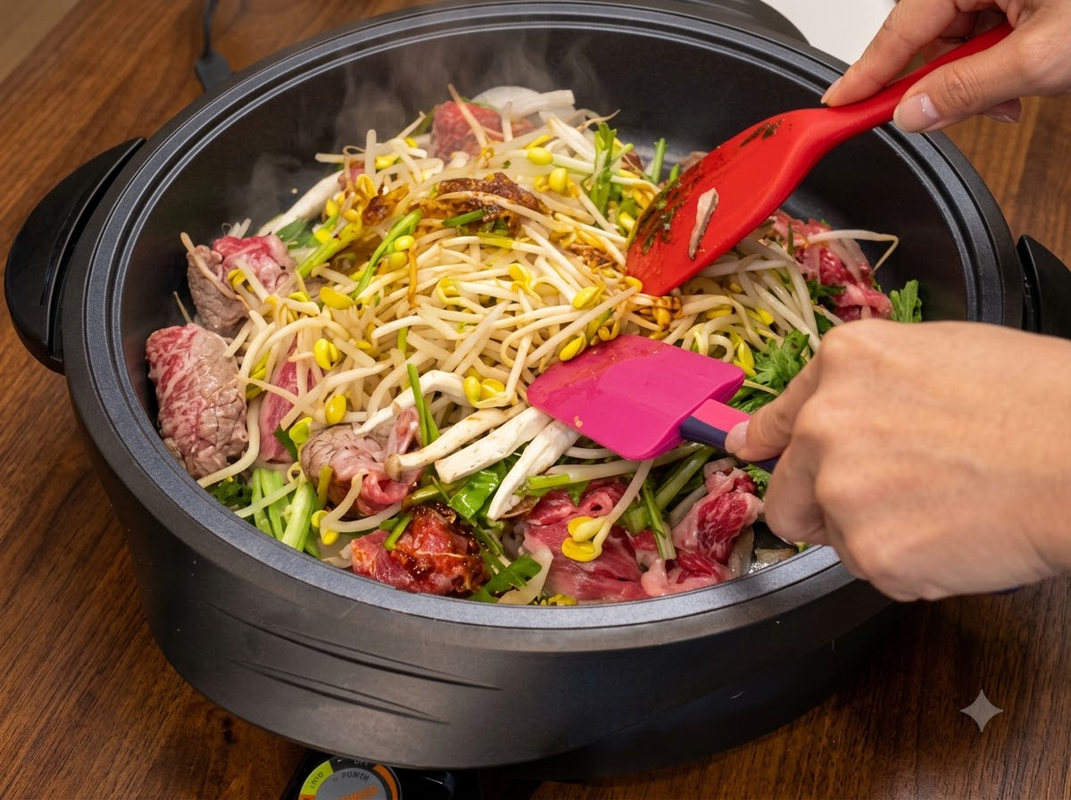 Two spatulas mixing and stir-frying ingredients inside a hot pan while more sauce is incorporated.