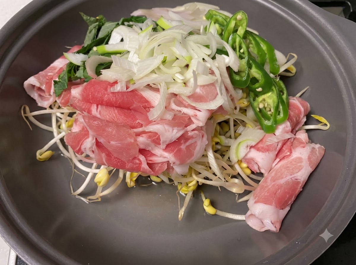 Sliced green onions and green chilies being added to the mix of ingredients.