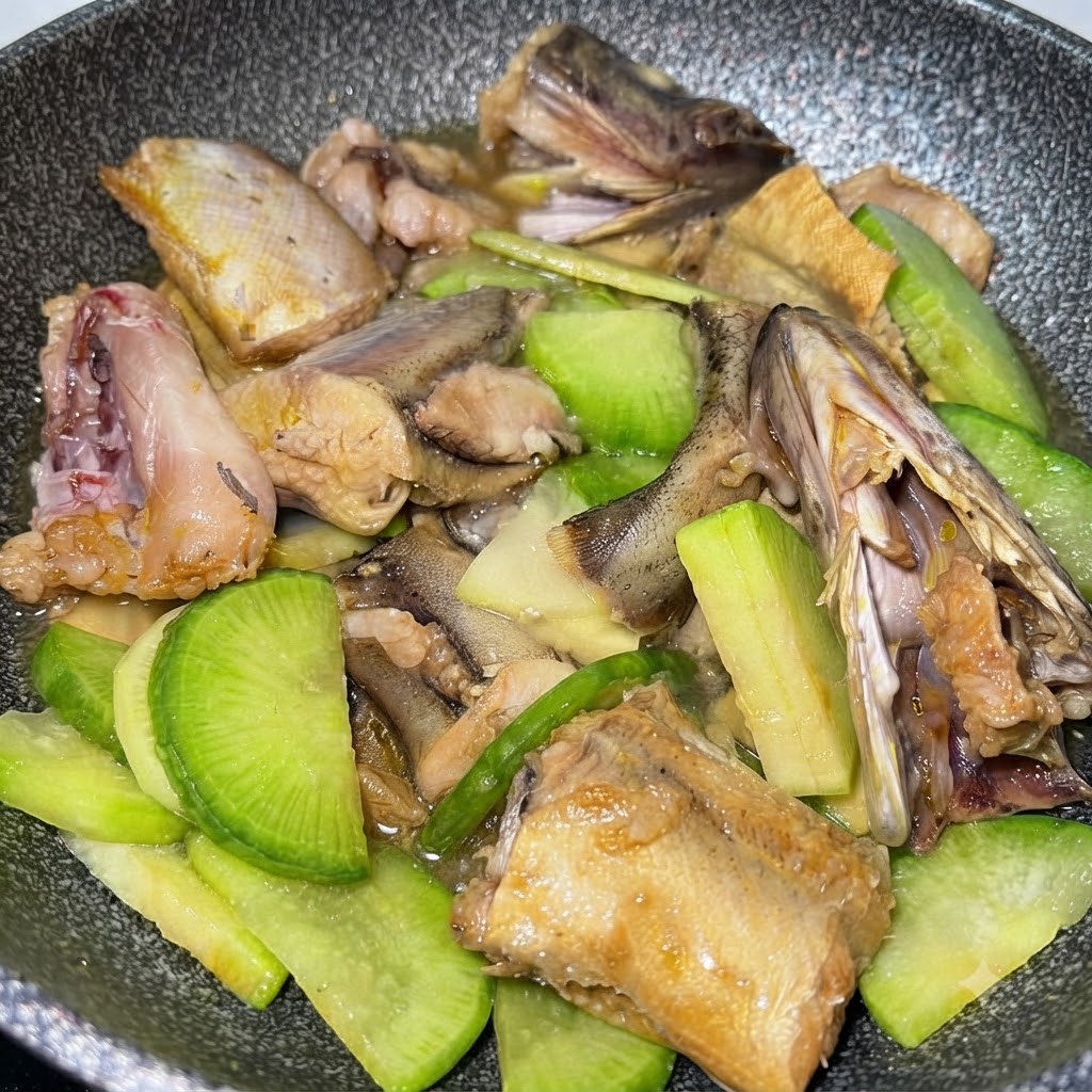 Water added to the pan covering the fish, potatoes, and green radish mixture.