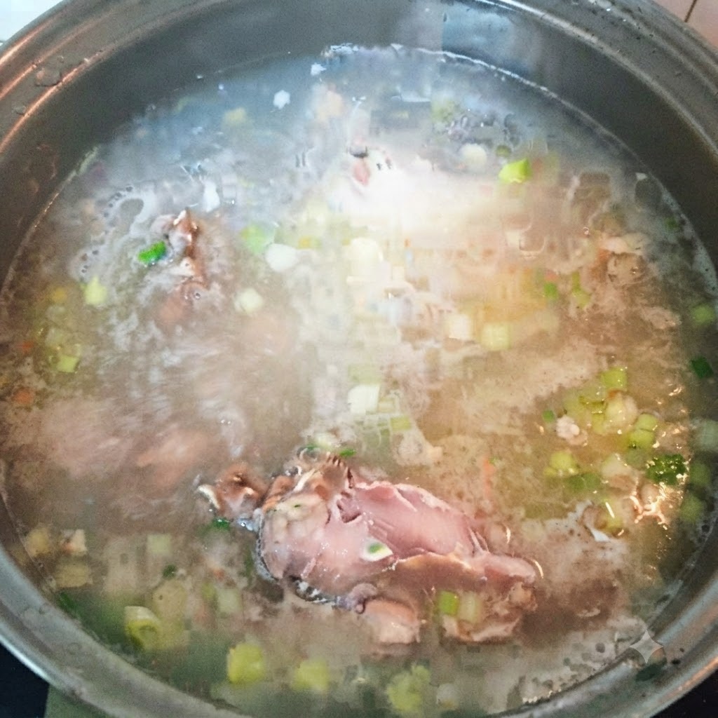 Remaining fish pieces being added to the boiling soup broth.