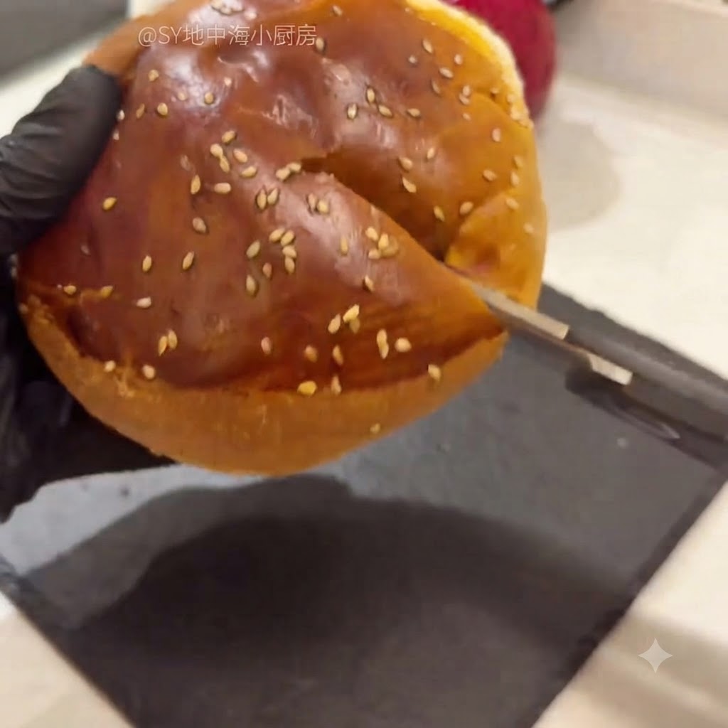 A hamburger bun cut open with kitchen scissors, with the soft inner bread being scooped out.
