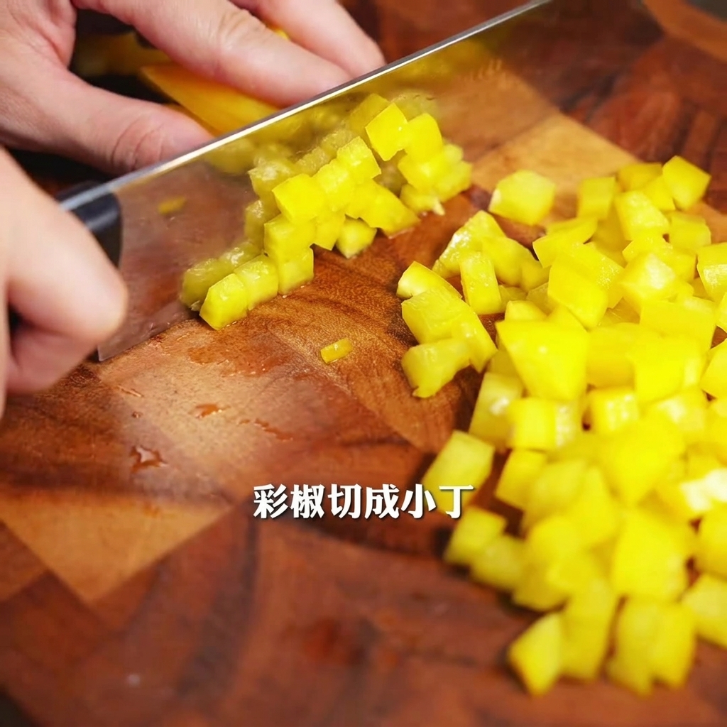 A yellow bell pepper being carefully chopped into small pieces on a wooden cutting board with a silver knife.