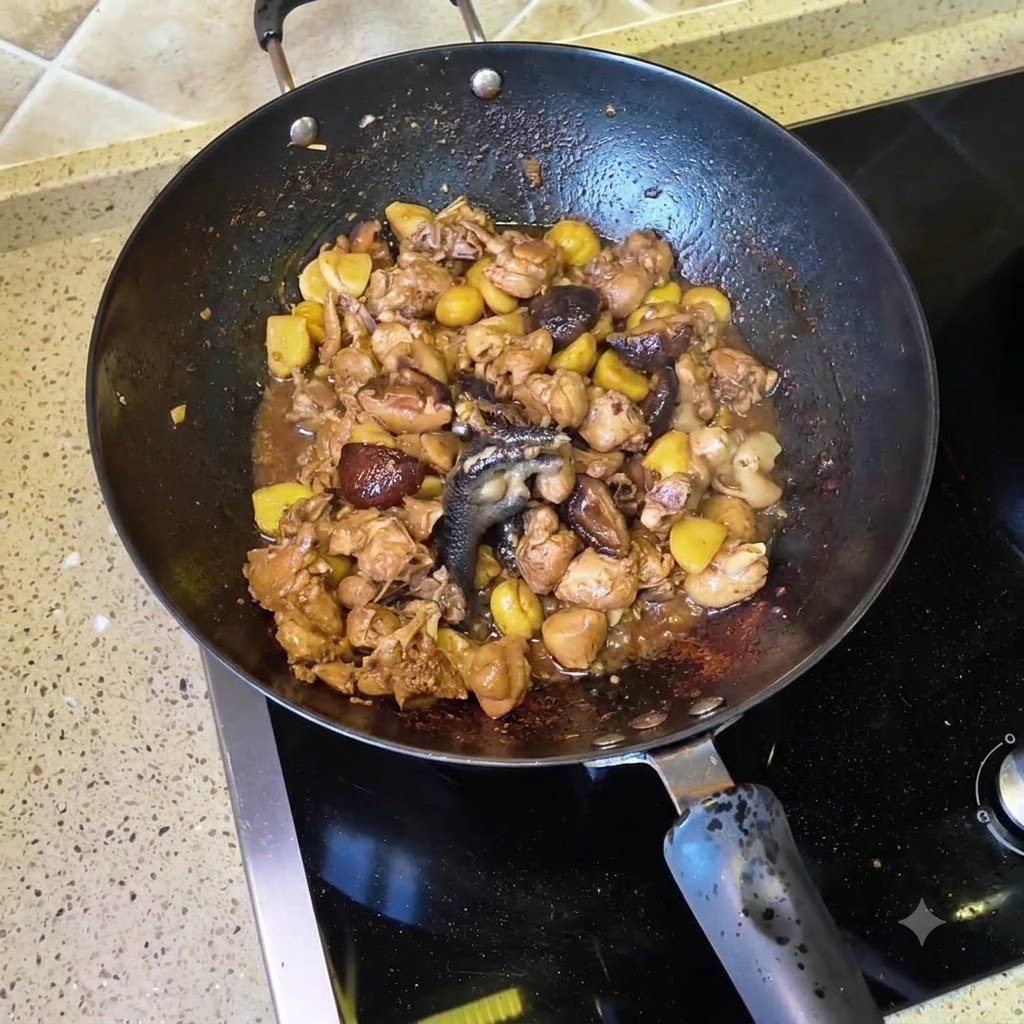 Water being poured into the wok filled with stir-fried chicken and shiitake mushrooms.