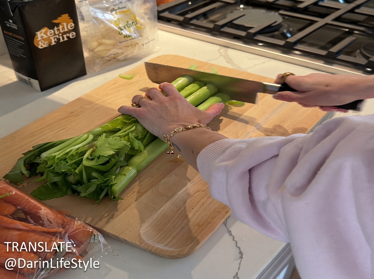 Green celery stalks being sliced into small pieces on a wooden cutting board with a knife.
