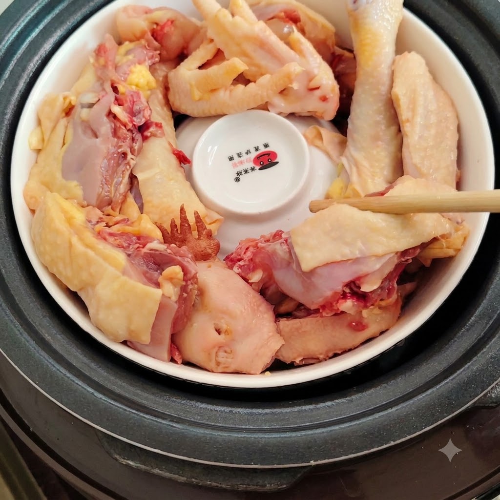 Chicken pieces arranged around the inverted bowl with fingers placing ingredients.