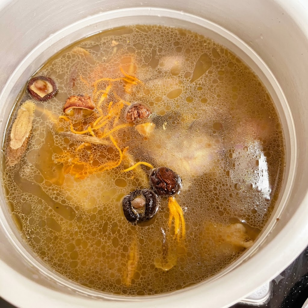 Salt being scooped and added into the pressure cooker filled with chicken and broth.