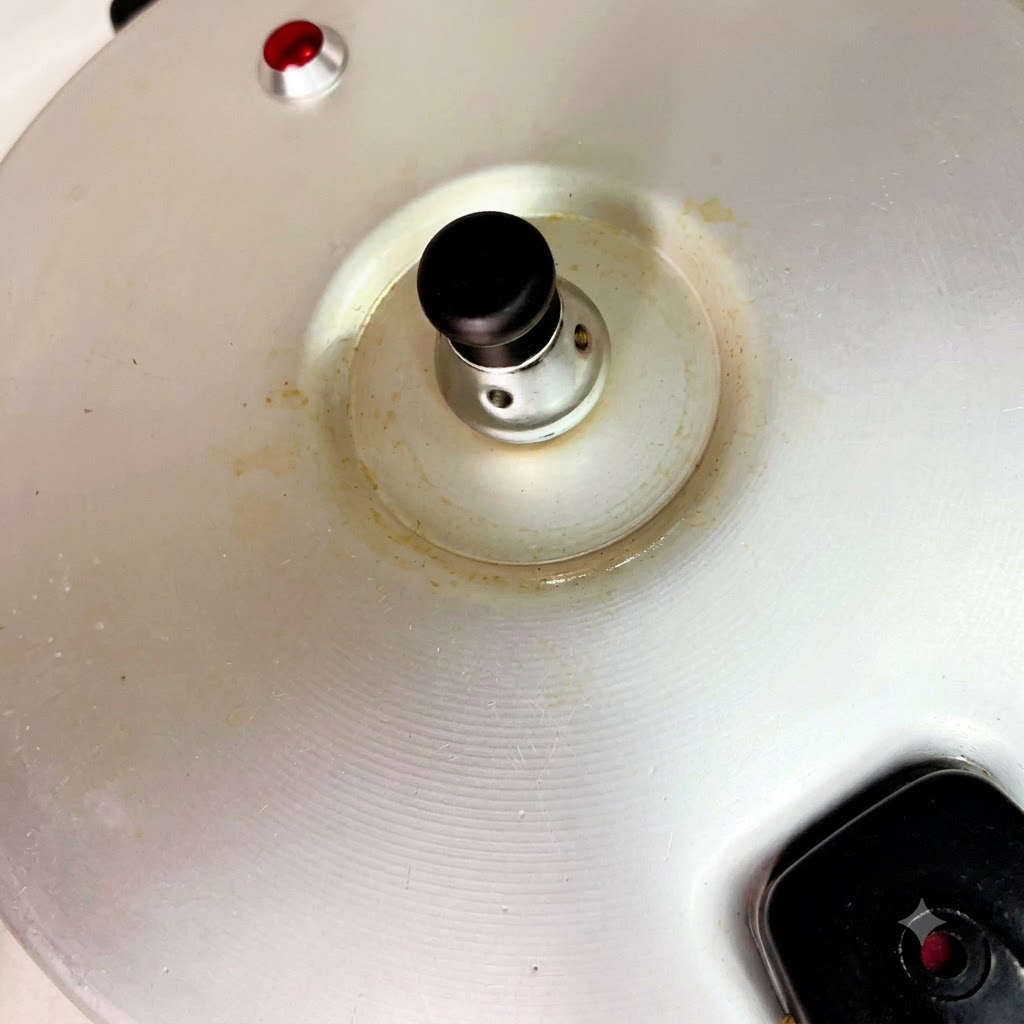 Red dates being dropped into the steaming pressure cooker pot.