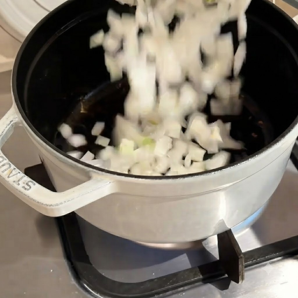 Chopped white onions falling down into a hot pot during the cooking process.