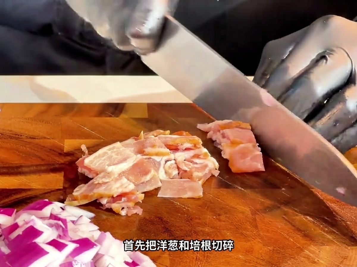 A knife slicing raw bacon into small strips on a wooden cutting board.