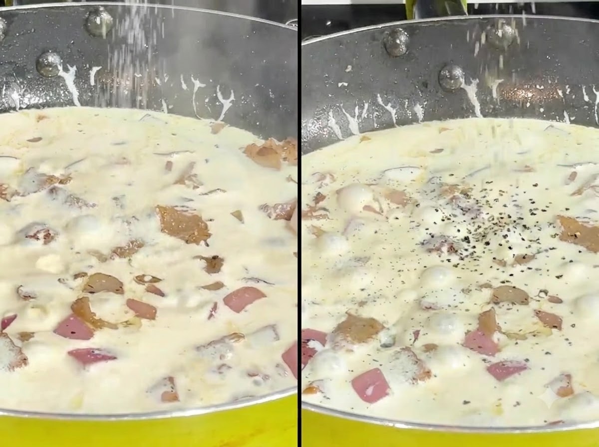 Salt and cracked black pepper being sprinkled onto a simmering cream sauce in a pan.