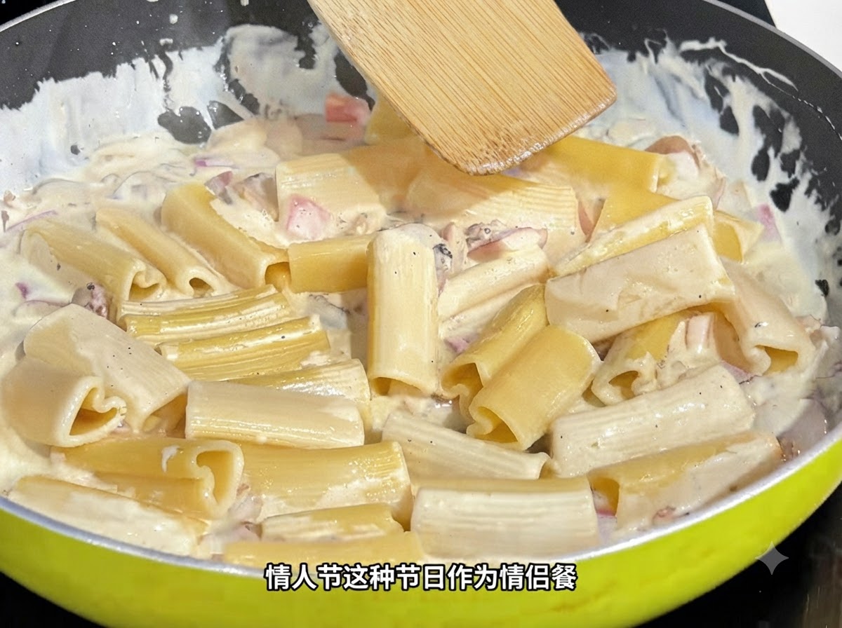 A wooden spatula stirring heart-shaped pasta in a creamy sauce inside a pan.