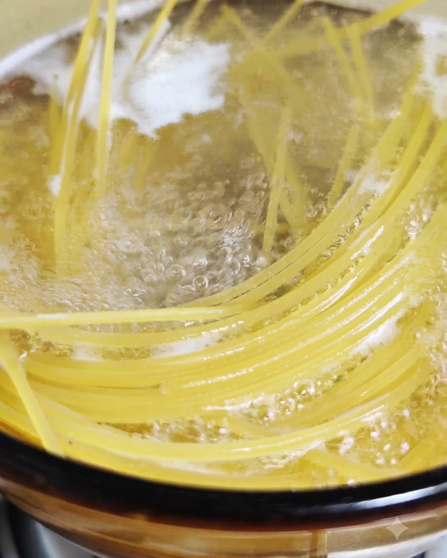 Spaghetti noodles cooking and bubbling in a pot of boiling salted water.