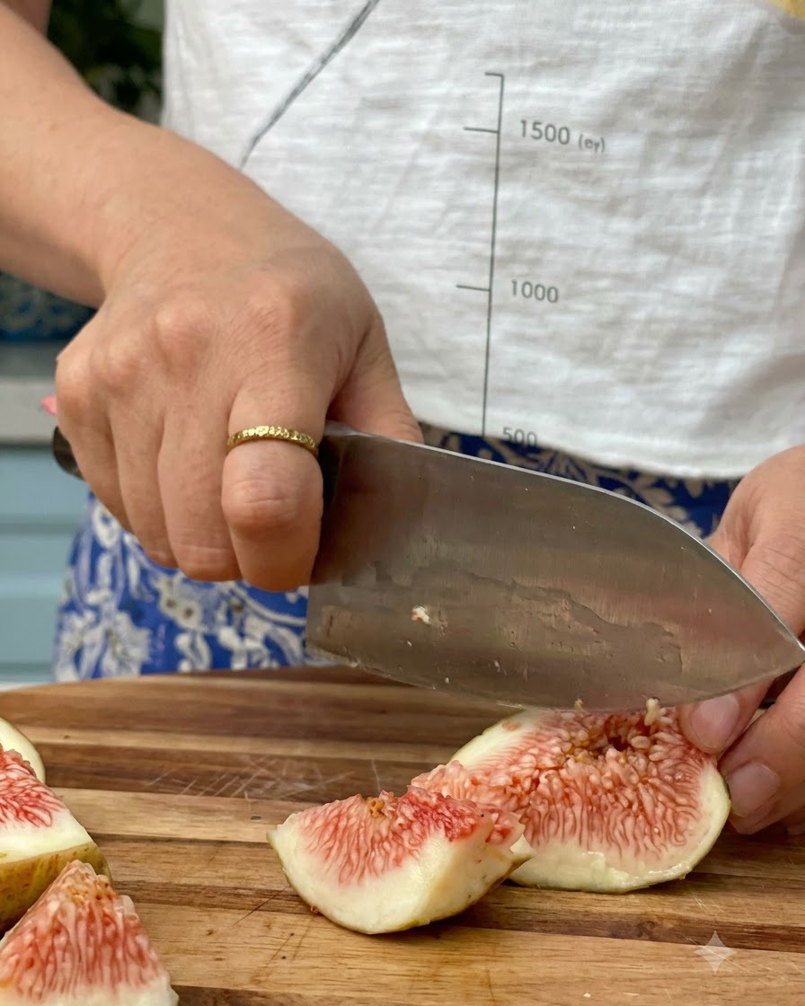 Chopped figs inside a saucepan with coconut sugar and rum ready for simmering.