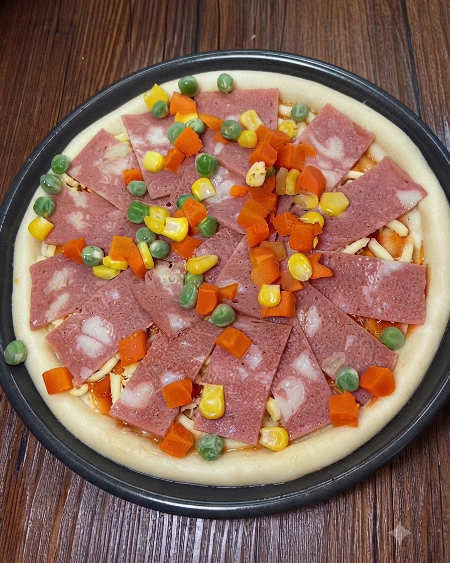 Additional shredded mozzarella cheese sprinkled on top of the pizza toppings.